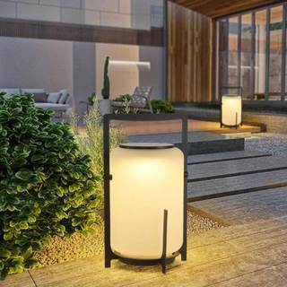Solar lamp in garden setting — modern warm ambient glow