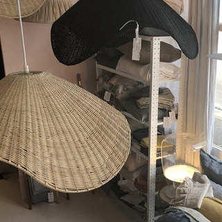 Rattan weave pendant casting dappled warm light