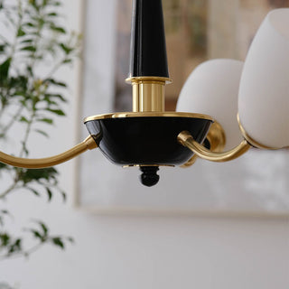 Black medieval chandelier detail — modern glass brass warm