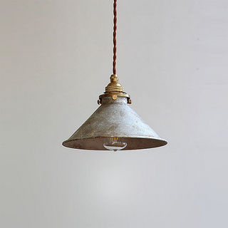 Vintage pendant showing brass and oxidized metal texture