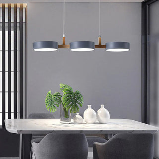 Iron wood three-head pendant over dining room table