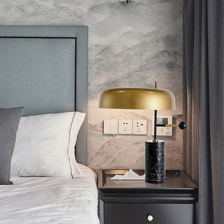 Black table lamp close-up — marble base gold shade detail