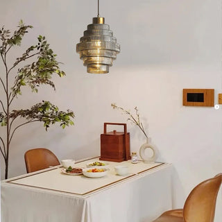 Striped glass shade pendant lamp with brass frame detail