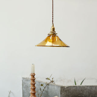 Single-head amber pendant over dining table
