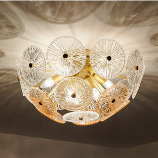 Modern starburst chandelier detail — gold glass sparkling warm texture