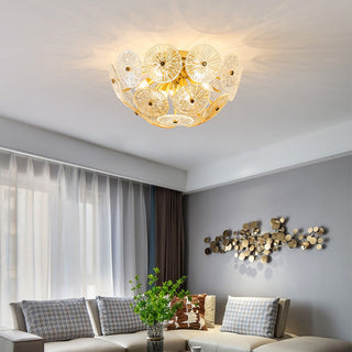 Modern starburst chandelier illuminated — gold glass sparkling warm