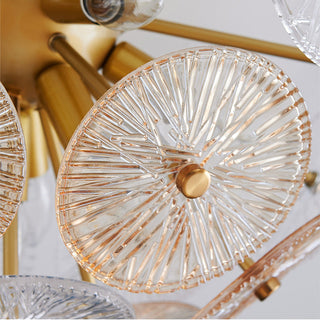 Gold starburst glass chandelier setting — modern sparkling wide