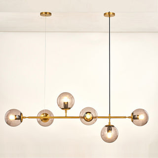 Modern glass bubble chandelier illuminated — long rod dining warm