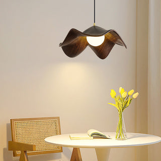 Wooden lotus pendant casting layered shadow on ceiling