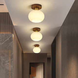 Minimalist white ceiling lamp close-up, wood glass brass detail