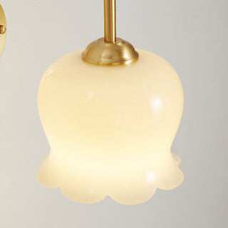 French flower wall sconce in bedroom — brass gold floral glass