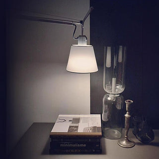 Rotatable silver wall lamp in living room — modern adjustable