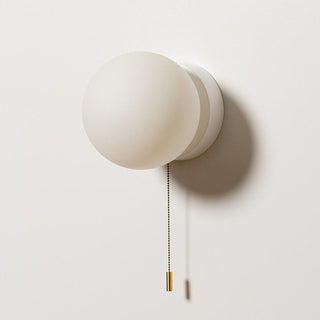 White pull cord Nordic mini wall sconce detail — bedroom