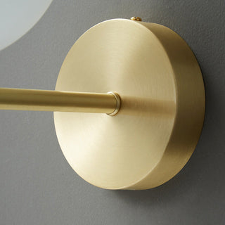 Cylindrical marble wall sconce copper base detail — bedside lamp