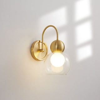 Brass glass rotatable wall light illuminated — mid-century sconce