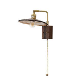 Brown glass retro wall sconce close-up — mid-century brass