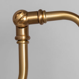 Gold finish minimalist brass wall sconce detail — industrial