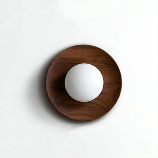 Round wooden frame natural wall sconce detail — minimalist