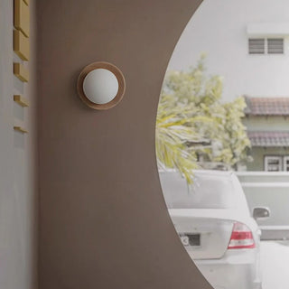 Natural wood wall lamp round minimalist in living room — sconce
