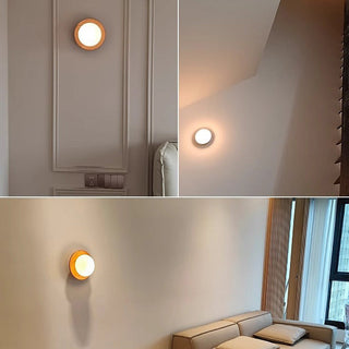 Minimalist round natural wood wall sconce ambient — lamp
