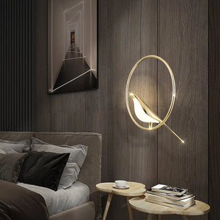 Pendant with gold bird motif on circular LED frame