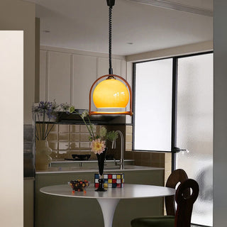Orange glass ball pendant detail — mid-century dining fixture
