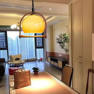 Mid-century orange ball pendant in interior — dining room lamp