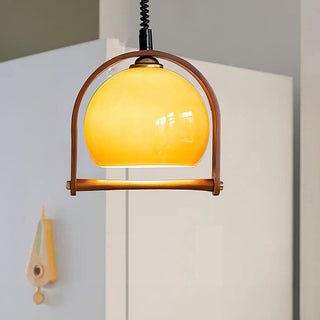 Orange glass ball pendant from below — mid-century hanging light