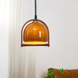 Orange glass ball pendant side view — mid-century dining fixture