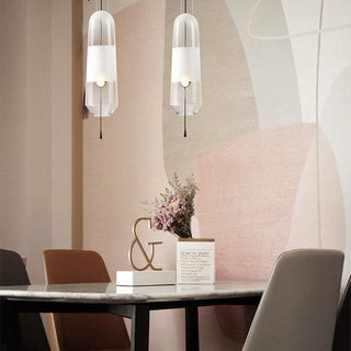 Glass capsule pendant close-up — sleek adjustable hanging lamp