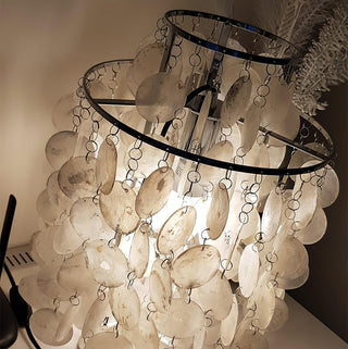 Handcrafted seashell table lamp illuminated — pearl warm glow