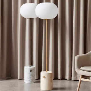 Modern globe floor lamp illuminated — marble glass warm