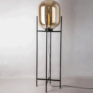 Oda amber glass lamp close-up — designer bowl black steel