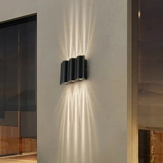 Outdoor LED wave sconce on exterior wall — modern waterproof wall light