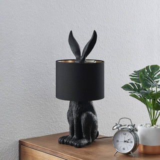 Resin masked rabbit lamp illuminated — white fabric warm glow