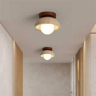 Industrial beige stone wall lamp in living room — walnut sconce