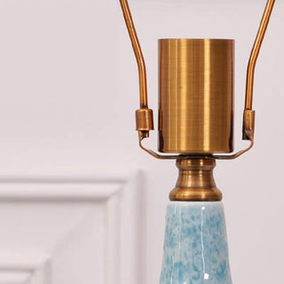 Ceramic table lamp close-up — fabric shade diffused detail