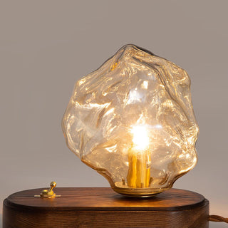 Modern glass table lamp illuminated — ice stone warm ambient