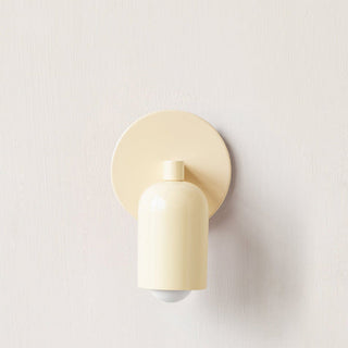 Small coloured glass wall sconce in living room — modern fixture