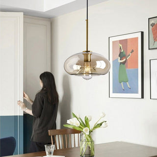 Industrial pendant with amber-tinted vintage glass shade