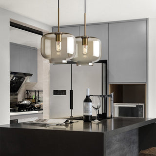 Industrial pendant with amber glass shade and warm light