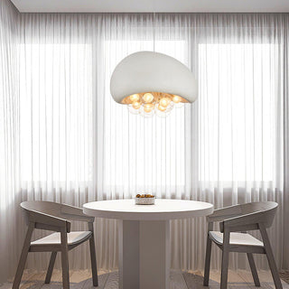 Cream textured pendant casting warm glow over dining table