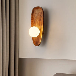 Minimalist wood wall sconce illuminated — solid living room