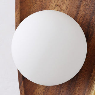 Solid wood minimalist wall lamp close-up — living room sconce