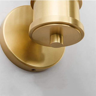 Brass gold crystal wall lamp close-up — modern dining sconce