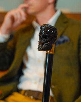 Black skull handle gothic gold-plated tip men's Italian luxury walking cane close-up