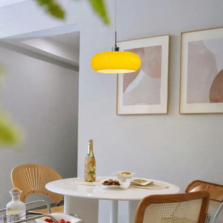 Bauhaus-style round glass pendant over dining table