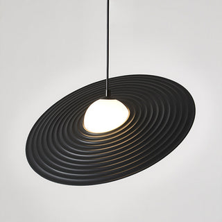 Flying saucer pendant close-up — modern black metal fabric fixture