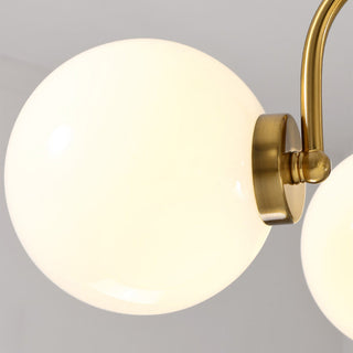 Nordic chrome chandelier illuminated — 3-globe glass warm living room