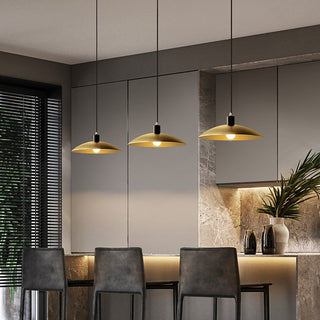 Brass bell pendant lamp hanging over dining table — antique style
